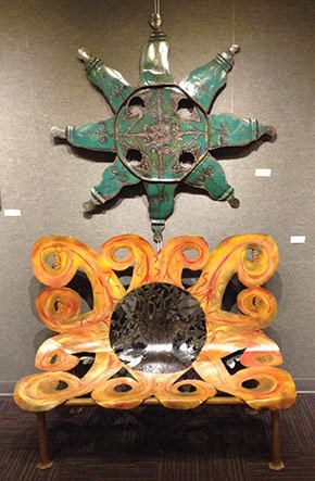 Metal sculpture displayed in a gallery.