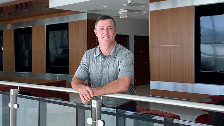 Photo of Keith Brown standing in the lobby of the Engineering and Math Building