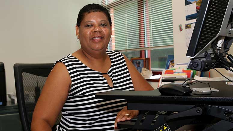 Photo of Cheryl Davis-Robinson sitting at her desk.