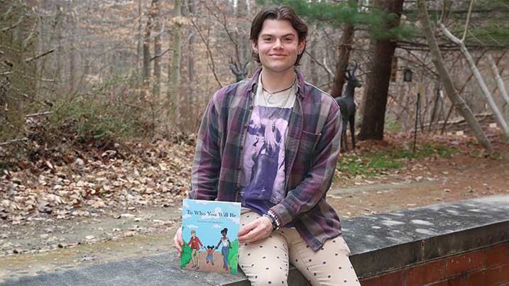 Ethan Kellum displays his first children's book.
