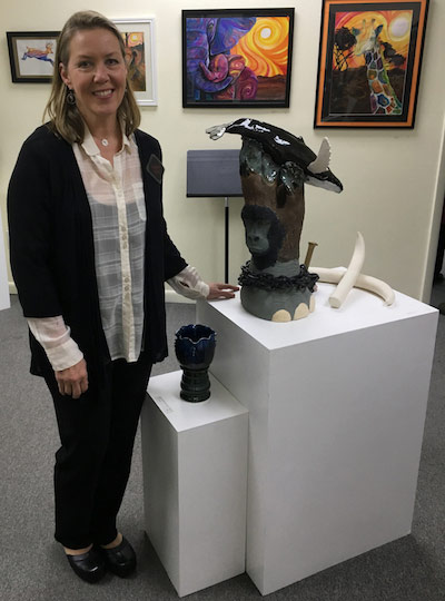 Laura Maloney standing beside her exhibit.