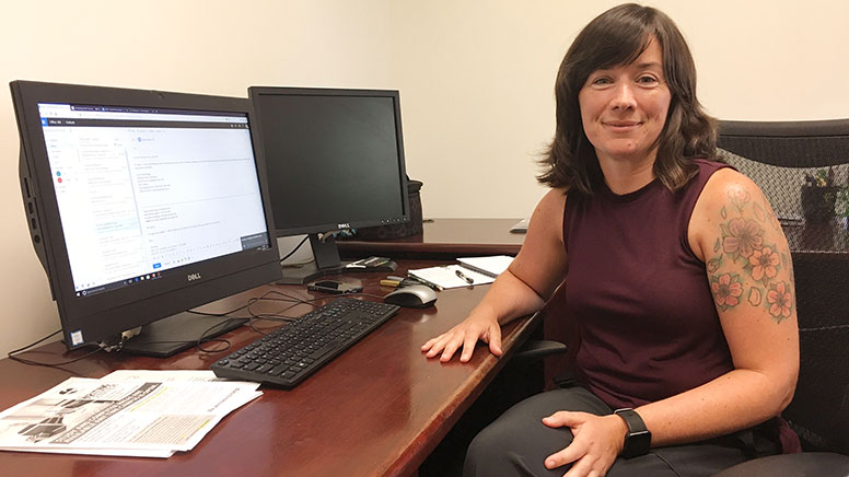 photo of Lauren Hornberger sitting at her desk