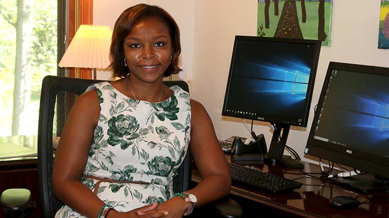 Lisa Wainwright sitting at her desk in the Foundation office.