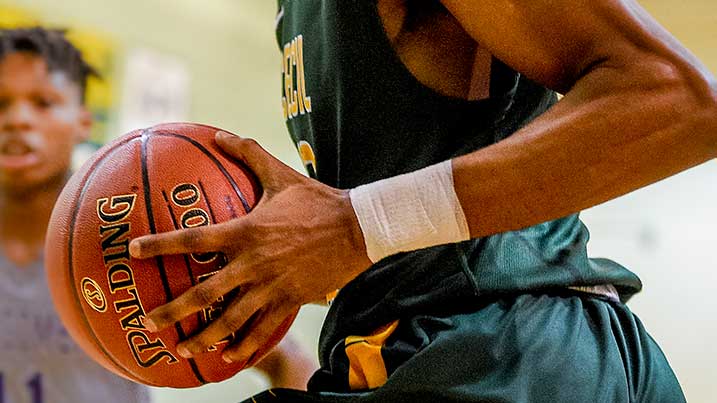 Basketball player holding a ball.