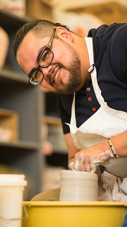 Oscar Zarco working on the pottery wheel