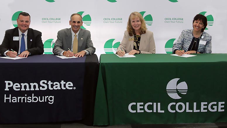 President Bolt and Penn State Chancellor sign an articulation agreement.