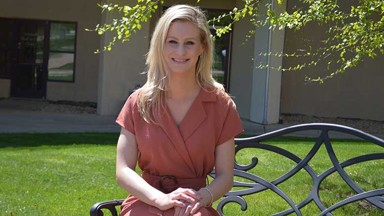 Rachel VanHorn is sitting on a bench in the quad of the North East Campus of Cecil College.