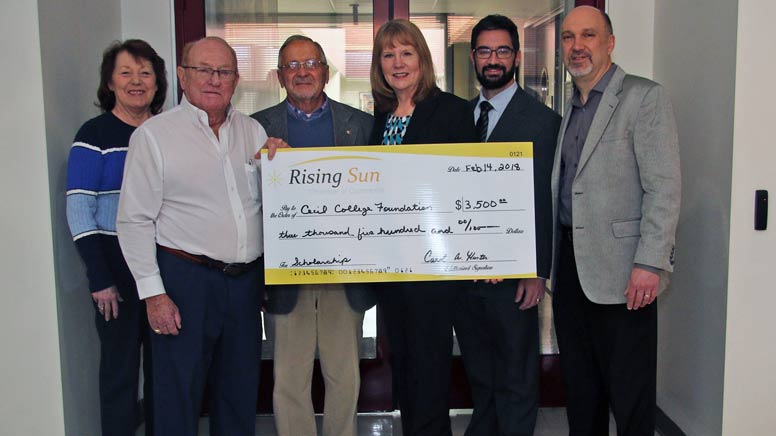 People holding a large check donated to the Cecil College Foundation by the Rising Sun Chamber of Commerce.