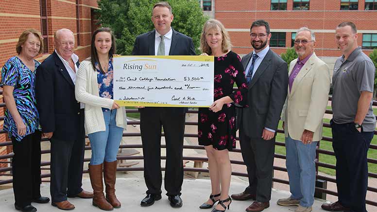 People holding a large check donated to the Cecil College Foundation by the Rising Sun Chamber of Commerce.