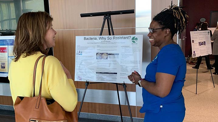 Student talking with a Cecil College staff member.