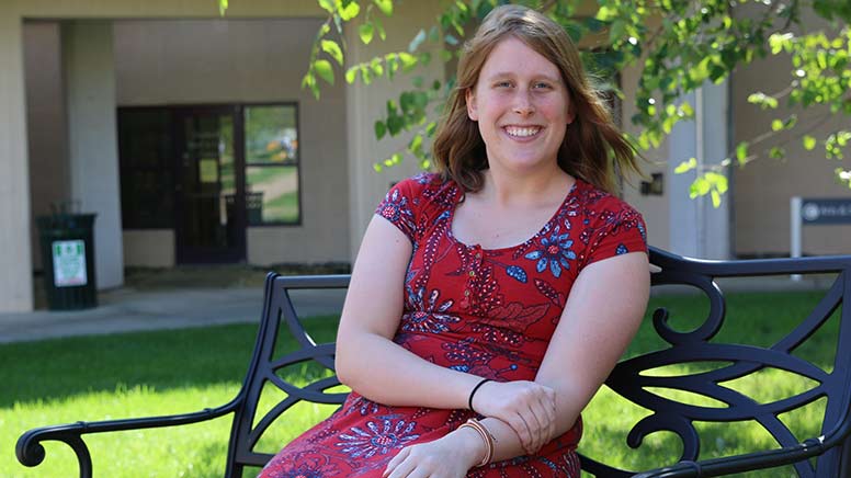 Sara La Cotti sitting on the bench in the quad.