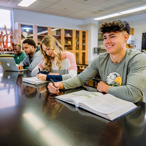 Cecil College students in anatomy lab with books