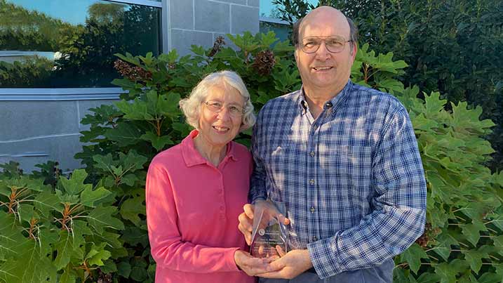 Photo of Barb and Jim Sweigard holding their presented award