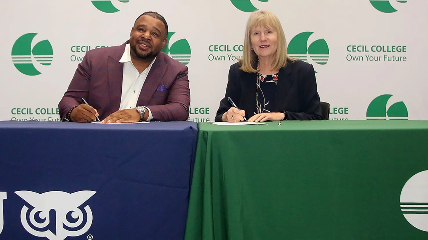 Western Governors University Northeast Regional Vice President Dr. K.L. Allen (left) signs a transfer articulation agreement with Cecil College President Dr. Mary Way Bolt during a signing ceremony on Thursday, May 1, 2025, in the lobby of the Milburn Stone Theatre on the North East Campus of Cecil College.