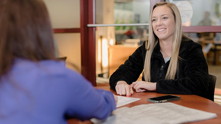 A person speaking with an admissions counselor.