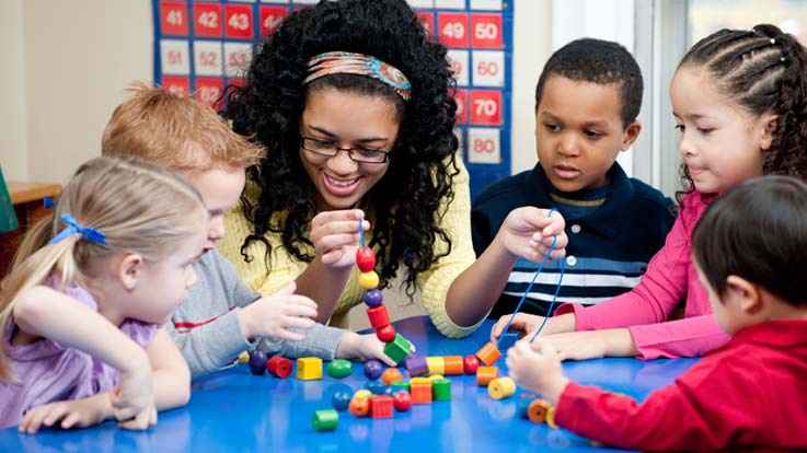 An adult playing with children.