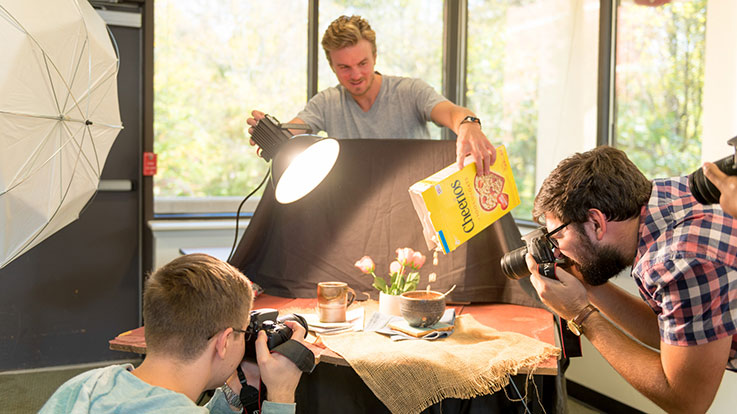 An instructor and students doing a photo shoot.