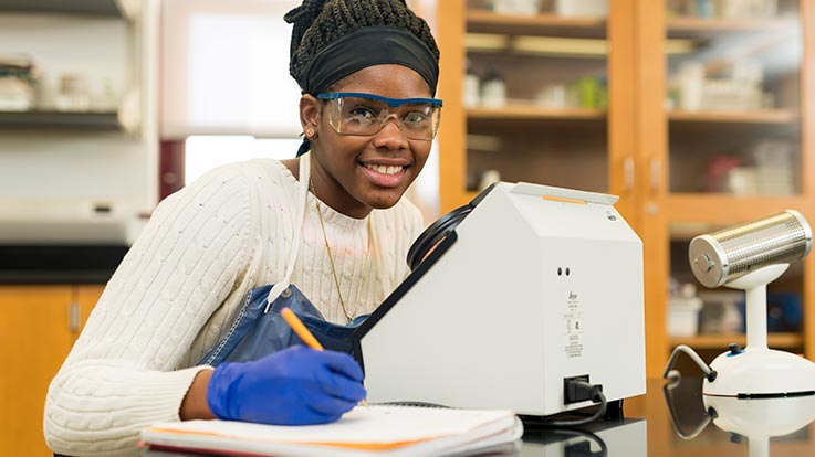 A student using lab equipment.