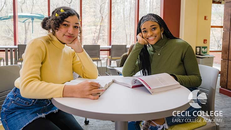 Two students at a table.