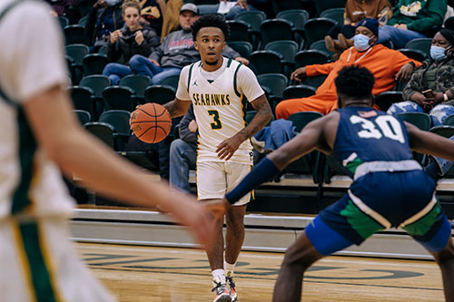 Basketball player dribbling a ball.