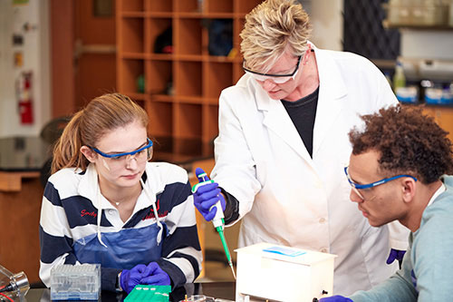 Students with an instructor in a lab.