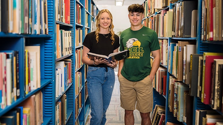 Two students in a library.