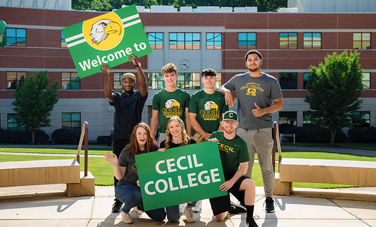 Students holding signs that say "Welcome to Cecil College."