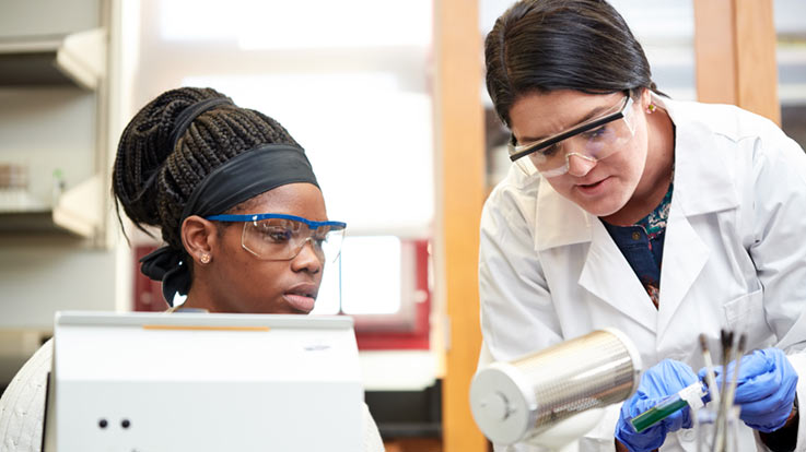 Instructor helping a student in the lab