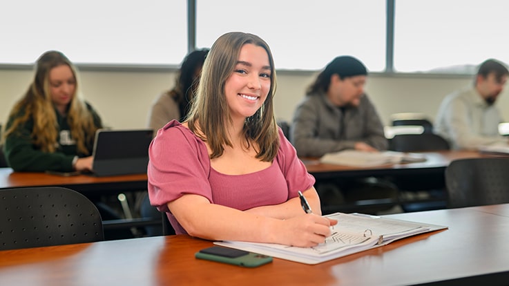 A student taking notes in class.